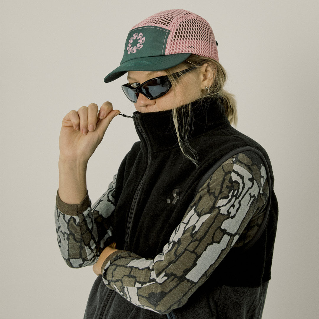 Two-tone black and gray vest with a logo on a white background
