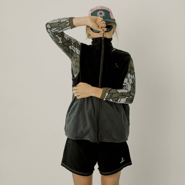 Two-tone black and gray vest with a logo on a white background