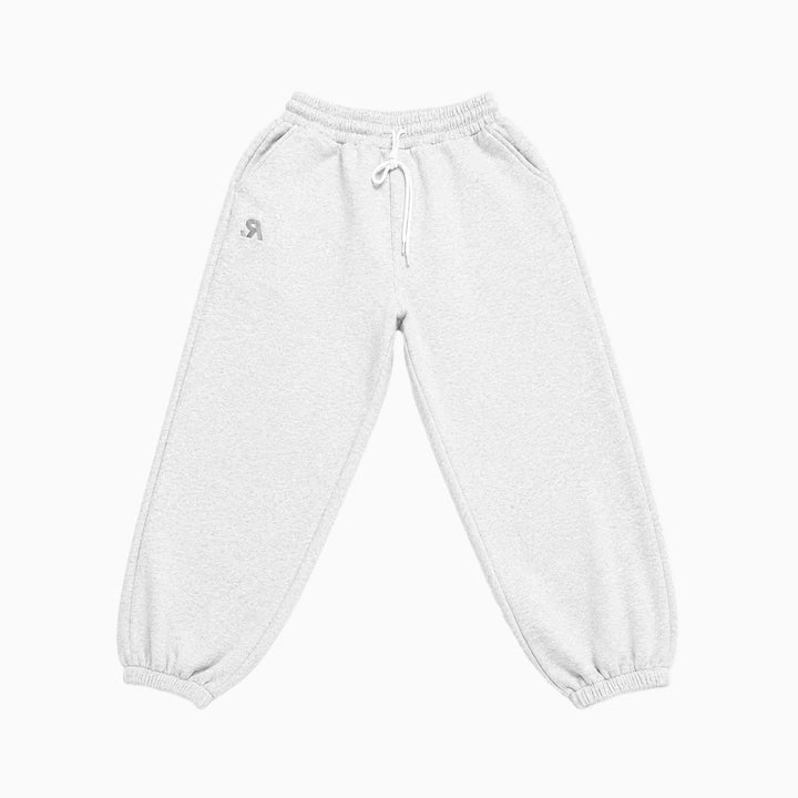 A pair of light gray heather sweatpants with an elastic waistband, white drawstring, and elastic cuffs, featuring a small gray logo on the left hip.